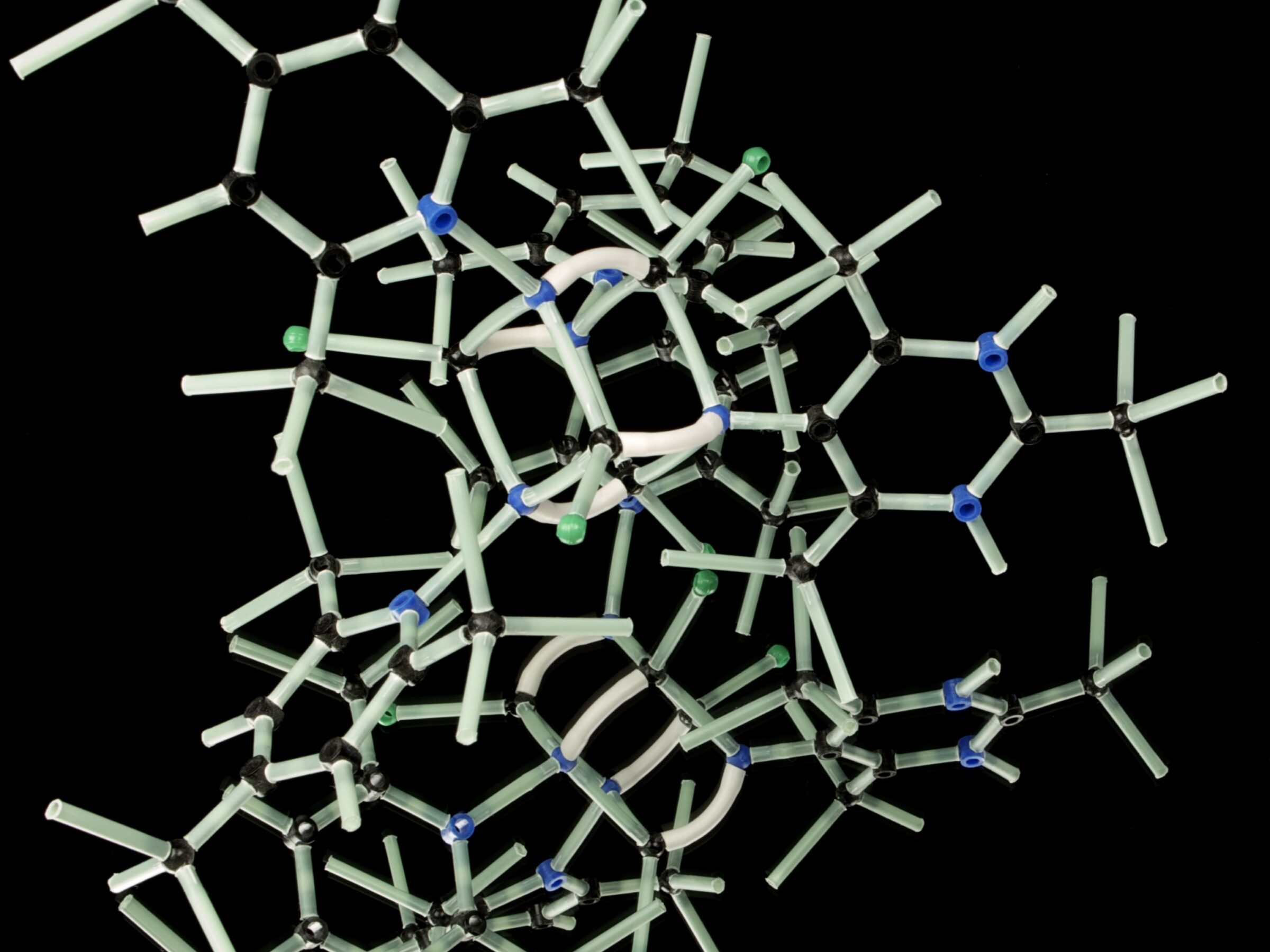 Picture of an illustration of a molecule with white bonds on a black background.